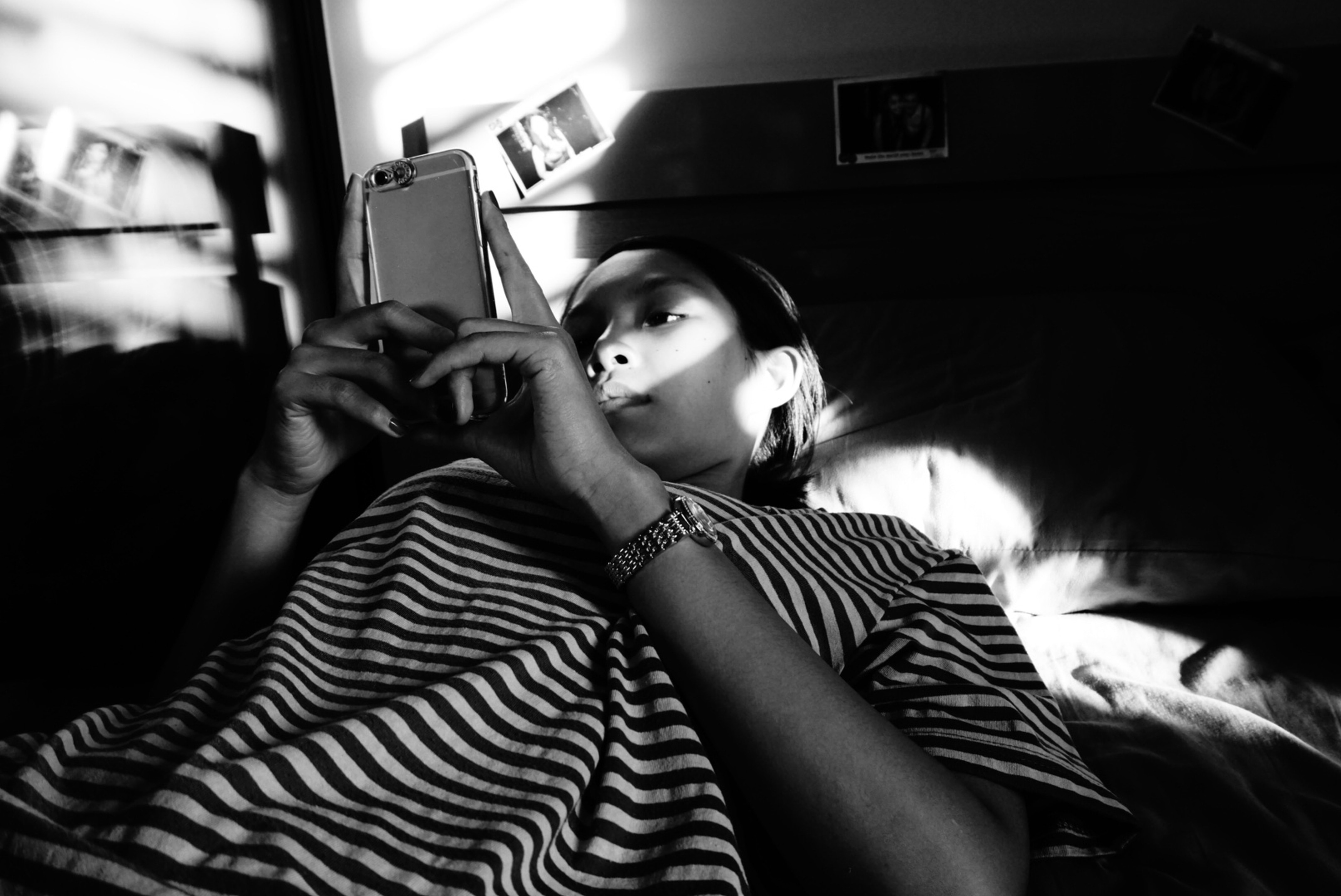 Girl checking smartphone at bedtime