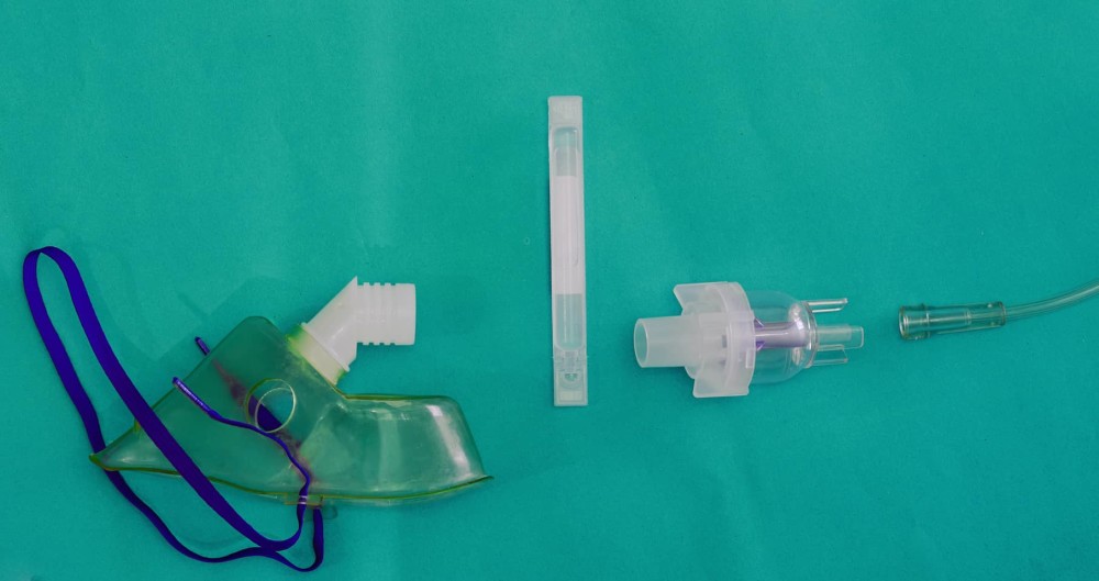 Inhaler and bronchodilator medicines on green background