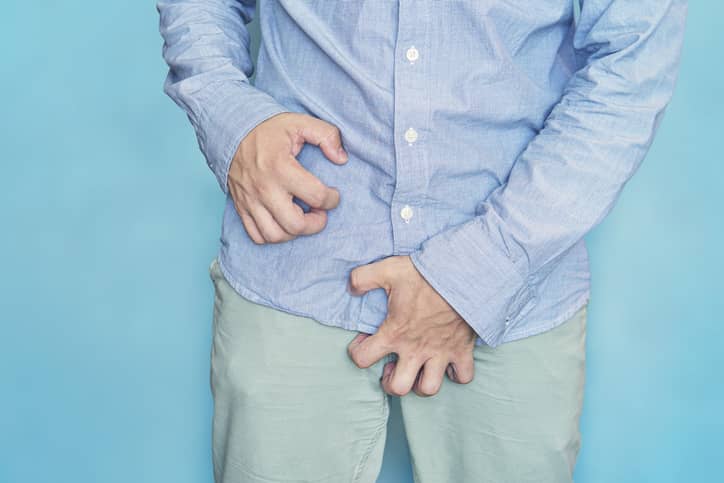 Man holding his crotch because he has an itchy penis