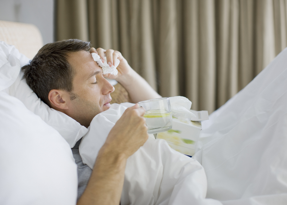 man in bed with a fever