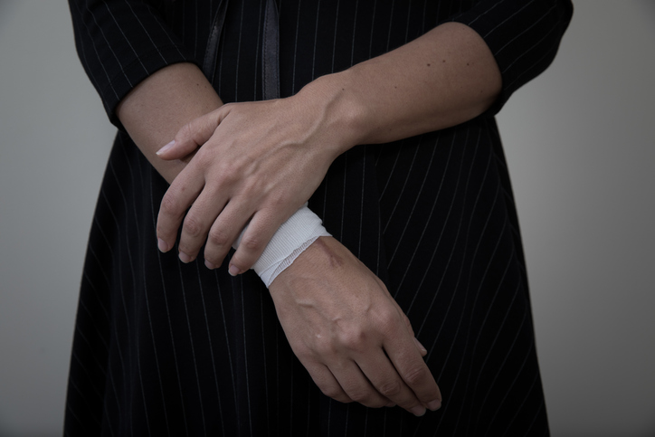 Middle view of woman wearing a bandage over one wrist