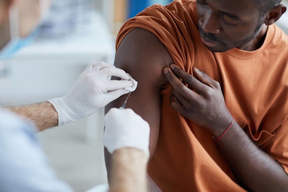 Person receiving COVID 19 vaccine 