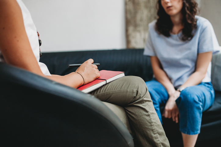 Woman talking to a psychologist in a studio