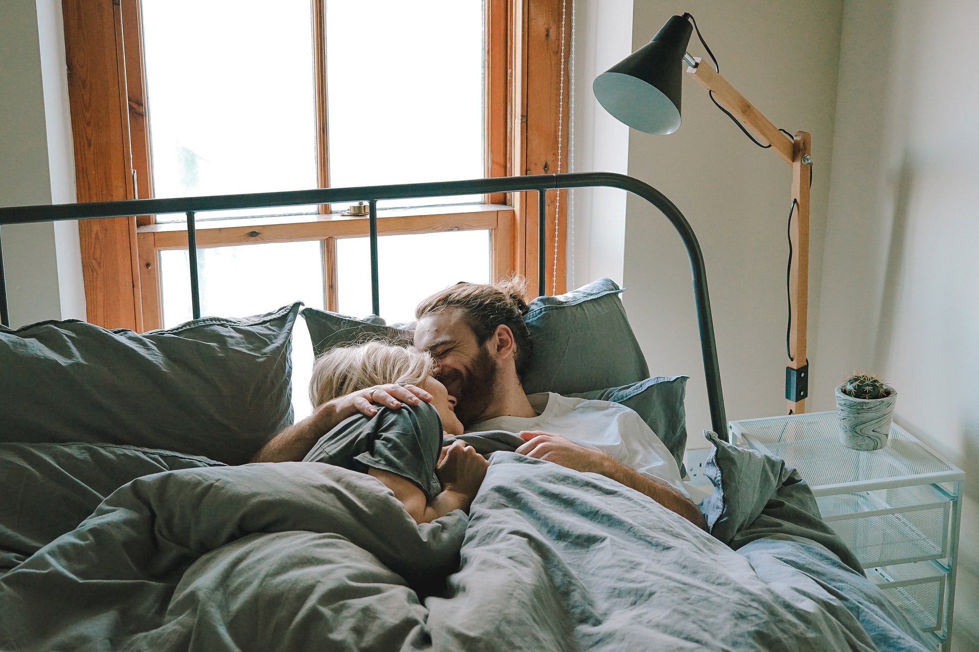 Young couple sharing cuddle in bed